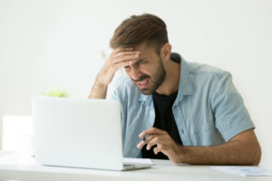Troubled man working on PC